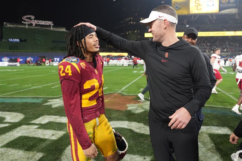 Dec 27, 2023; San Diego, CA, USA; Southern California Trojans head coach Lincoln Riley (right) celebrates with wide receiver Makai Lemon (24) after the Holiday Bowl against the Louisville Cardinals at Petco Park. Mandatory Credit: Kirby Lee-USA TODAY Sports