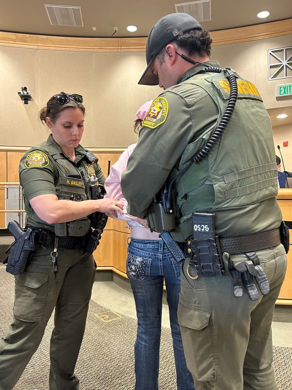 Shasta County Sheriff's deputies handcuff Jenny Nowain-O'Connell at the Tuesday, April 27, 2026, supervisors meeting.