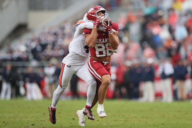 Oct 25, 2025; Fayetteville, Arkansas, USA; Arkansas Razorbacks tight end Rohan Jones (88) catches a pass in the third quarter as Auburn Tigers cornerback Kayin Lee (4) defends at Donald W. Reynolds Razorback Stadium. Mandatory Credit: Nelson Chenault-Imagn Images