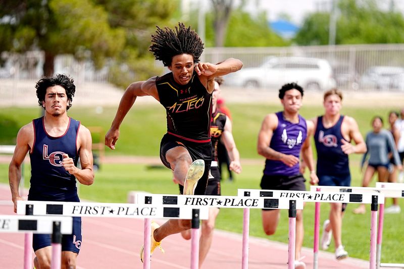 Palm Desert’s Kingston Penny, center, wins the 300-meter hurdles at the Desert Empire League track finals in La Quinta, Calif., on Thurs., April 30, 2026.