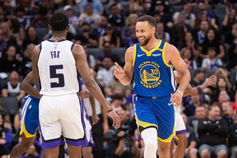 Oct 9, 2024; Sacramento, California, USA; Golden State Warriors guard Stephen Curry (30) motions to Sacramento Kings guard De'Aaron Fox (5) after scoring during the second quarter at Golden 1 Center. Mandatory Credit: Ed Szczepanski-Imagn Images