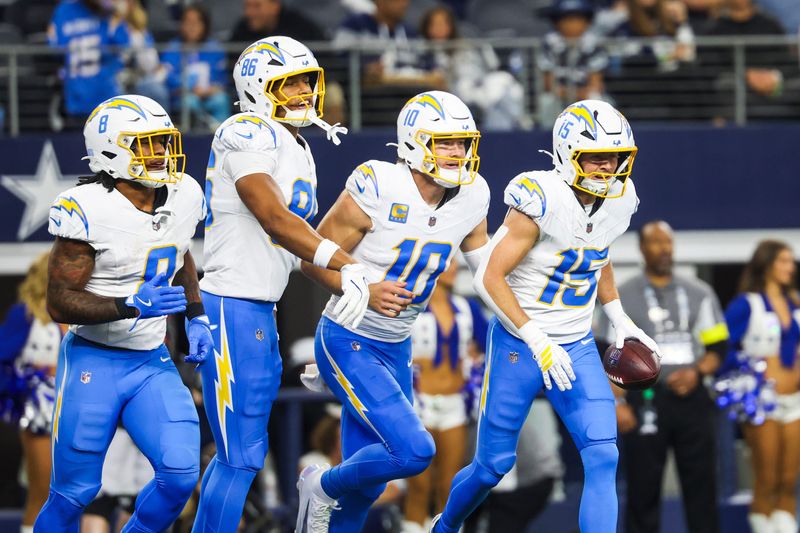 Dec 21, 2025; Arlington, Texas, USA; Los Angeles Chargers wide receiver Ladd McConkey (15) returns to the bench with running back Omarion Hampton (8), tight end Will Dissly (89) and quarterback Justin Herbert (10) after catching a touchdown pass from Herbert against the Dallas Cowboys during the second quarter at AT&T Stadium. Mandatory Credit: Kevin Jairaj-Imagn Images