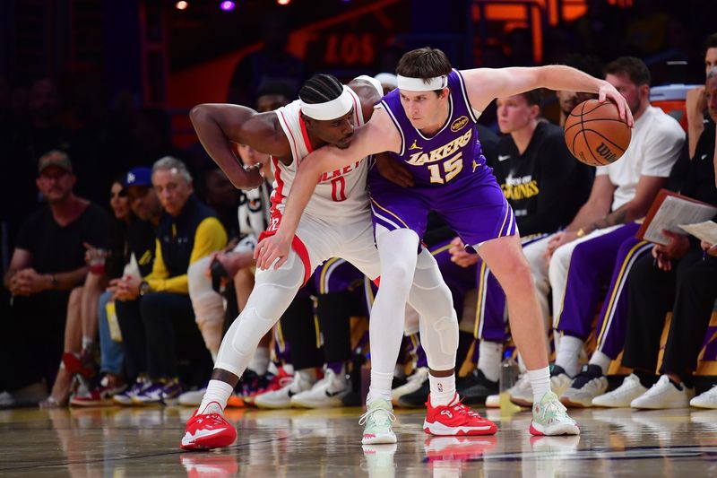 Apr 29, 2026; Los Angeles, California, USA; Los Angeles Lakers guard Austin Reaves (15) moves the ball against Houston Rockets guard Aaron Holiday (0) during the second half in game five of the first round of the 2026 NBA Playoffs at Crypto.com Arena. Mandatory Credit: Gary A. Vasquez-Imagn Images