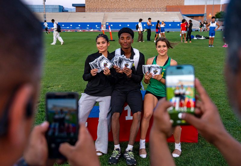 Coachella Valley's Paulina Lucero (left), Fernando Avina and Jaylynn Hernandez show off their patches after the DVL track and field finals in Indio, Calif., Thursday, April 30, 2026.
