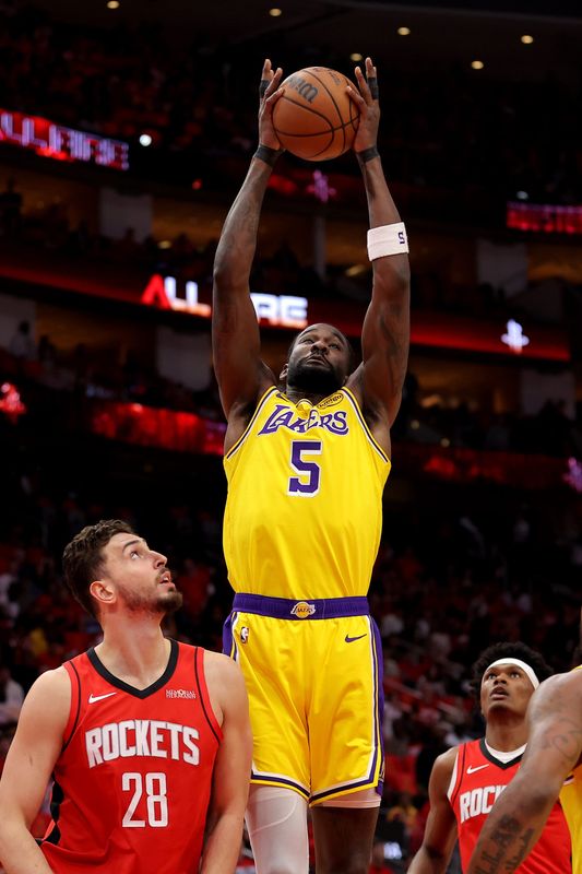 May 1, 2026; Houston, Texas, USA; Los Angeles Lakers center Deandre Ayton (5) rebounds against the Houston Rockets during the first quarter game six of the first round of the 2026 NBA Playoffs at Toyota Center. Mandatory Credit: Erik Williams-Imagn Images