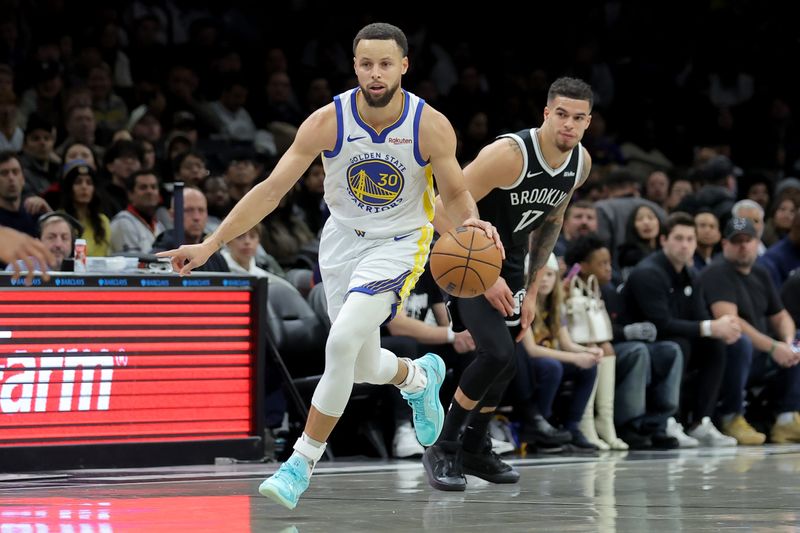 Dec 29, 2025; Brooklyn, New York, USA; Golden State Warriors guard Stephen Curry (30) brings the ball up court against Brooklyn Nets forward Michael Porter Jr. (17) during the first quarter at Barclays Center. Mandatory Credit: Brad Penner-Imagn Images