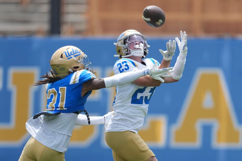 May 2, 2026; Pasadena, CA, USA; UCLA Bruins receiver Jackson Meehan (23) attempts to catch the ball against defensive back Chase Coleman (31) during the spring game at Rose Bowl. Mandatory Credit: Kirby Lee-Imagn Images