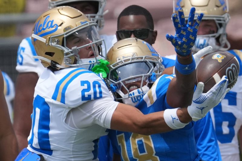 May 2, 2026; Pasadena, CA, USA; UCLA Bruins receiver Shane Rosenthal (20) attempts to catch the ball against derfensive back Osiris Gilbert (18) during the spring game at Rose Bowl. Mandatory Credit: Kirby Lee-Imagn Images