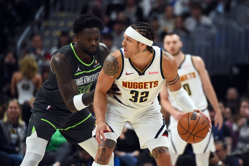 Apr 18, 2026; Denver, Colorado, USA; Denver Nuggets forward Aaron Gordon (32) handles the ball against Minnesota Timberwolves forward Julius Randle (30) during the first half in game one of the first round of the 2026 NBA Playoffs at Ball Arena. Mandatory Credit: Christopher Hanewinckel-Imagn Images