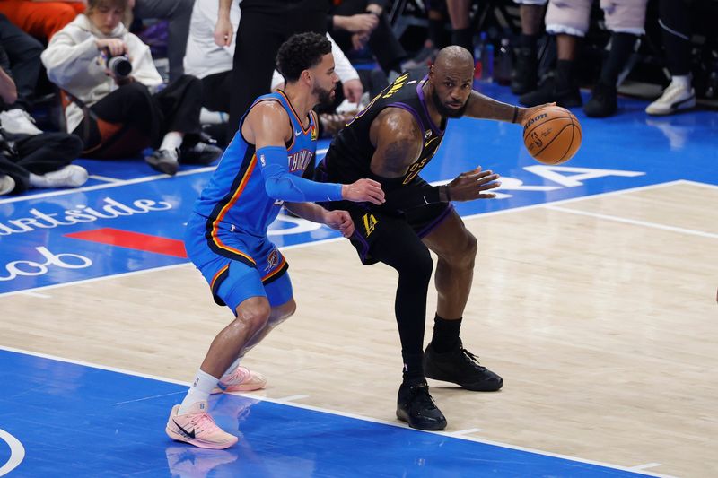 Apr 2, 2026; Oklahoma City, Oklahoma, USA; Los Angeles Lakers forward LeBron James (23) drives against Oklahoma City Thunder guard Ajay Mitchell (25) during the second quarter at Paycom Center. Mandatory Credit: Alonzo Adams-Imagn Images