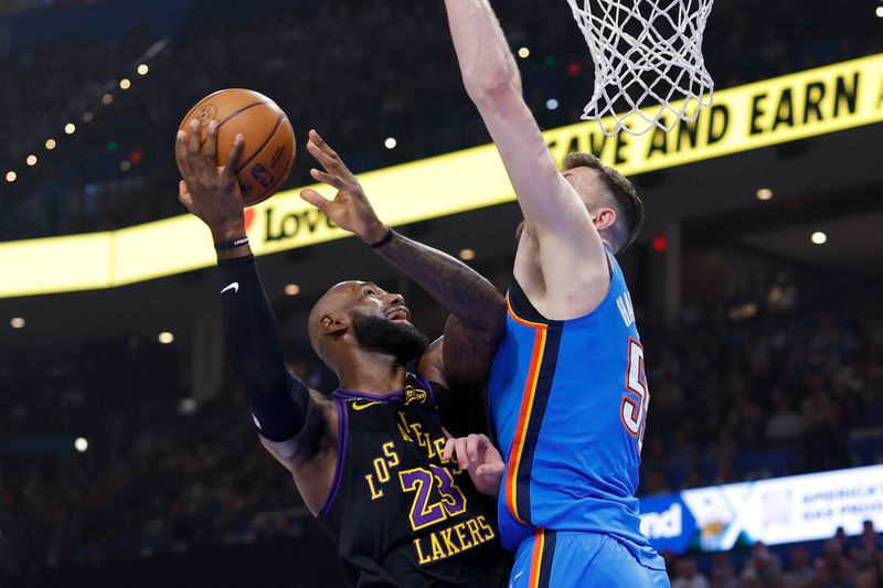 Apr 2, 2026; Oklahoma City, Oklahoma, USA; Los Angeles Lakers forward LeBron James (23) goes up for a basket as Oklahoma City Thunder center Isaiah Hartenstein (55) defends during the first quarter at Paycom Center. Mandatory Credit: Alonzo Adams-Imagn Images