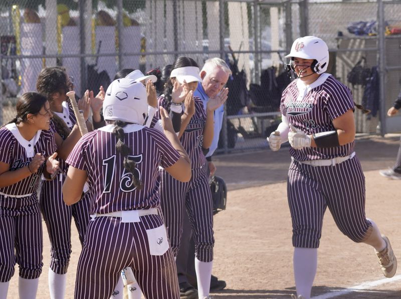 University Prep's Paityn Zimmerman is met by teammates after hitting a home run against Victor Valley on Tuesday, May 5, 2026. Zimmerman helped lead the Jaguars to a 13-5 victory.