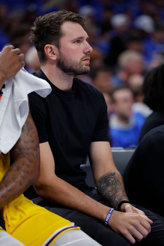May 5, 2026; Oklahoma City, Oklahoma, USA; Los Angeles Lakers guard Luka Doncic (77) watches his team play against the Oklahoma City Thunder in the first half during game one of the second round of the 2026 NBA Playoffs at Paycom Center. Mandatory Credit: Alonzo Adams-Imagn Images