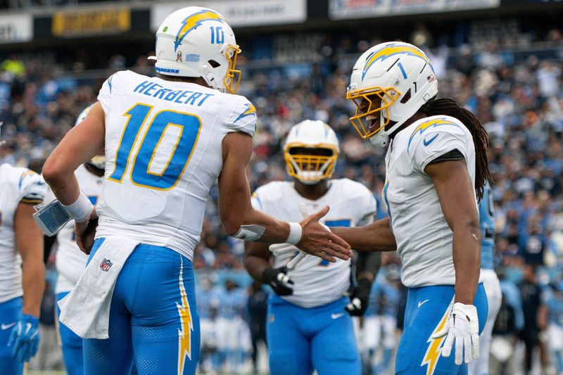 Nov 2, 2025; Nashville, Tennessee, USA; Los Angeles Chargers quarterback Justin Herbert (10) celebrates his touchdown with wide receiver Quentin Johnston (1) against the Tennessee Titans during the first half at Nissan Stadium. Mandatory Credit: Steve Roberts-Imagn Images