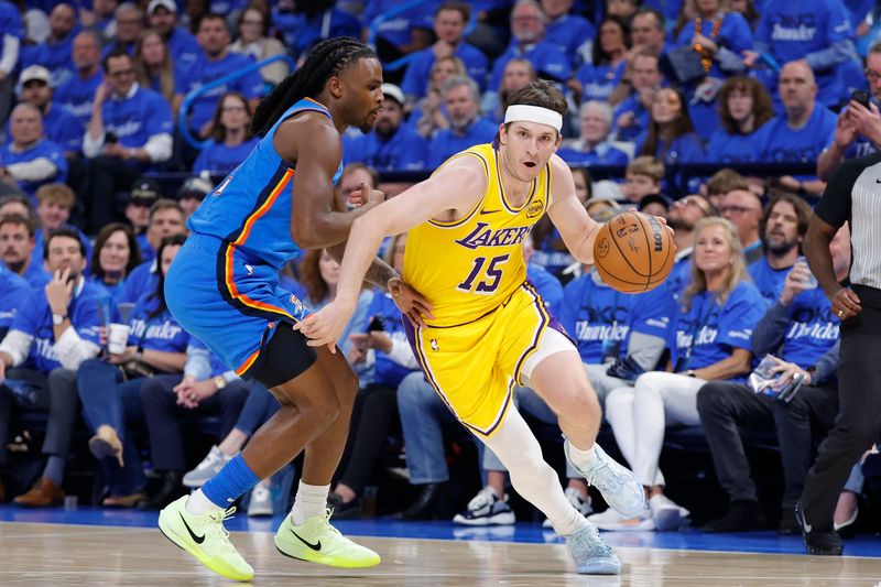 May 5, 2026; Oklahoma City, Oklahoma, USA; Los Angeles Lakers guard Austin Reaves (15) drives around Oklahoma City Thunder guard Cason Wallace (22) in the first half during game one of the second round of the 2026 NBA Playoffs at Paycom Center. Mandatory Credit: Alonzo Adams-Imagn Images