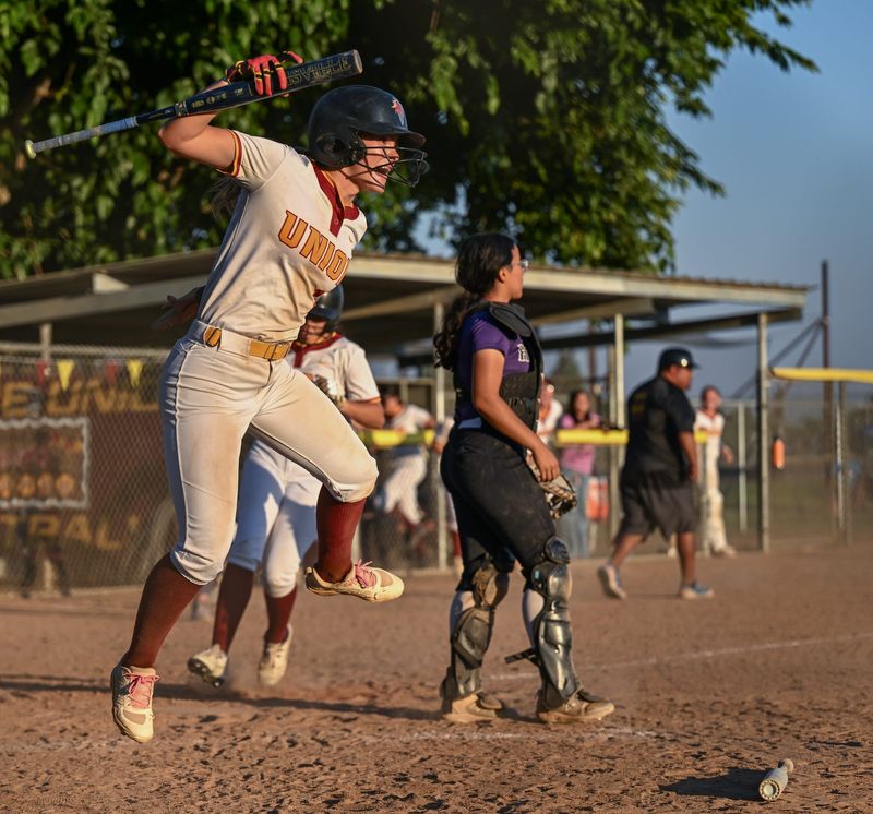Tulare Union's Jiannah Freitas, left, celebrates as Jazlene Salazar scores on a hit by Tulare Union's Kayloni Cox to win the game against Mission Oak in West Yosemite League high school softball Wednesday, May 6, 2026.