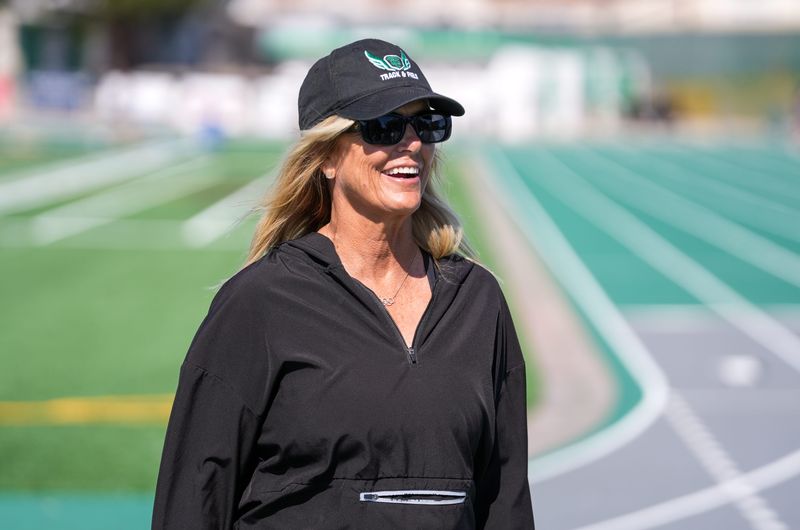 Thousand Oaks track and field head coach Marlene Wilcox smiles while talking to her athletes at a May 7, 2026, practice at Thousand Oaks High School.