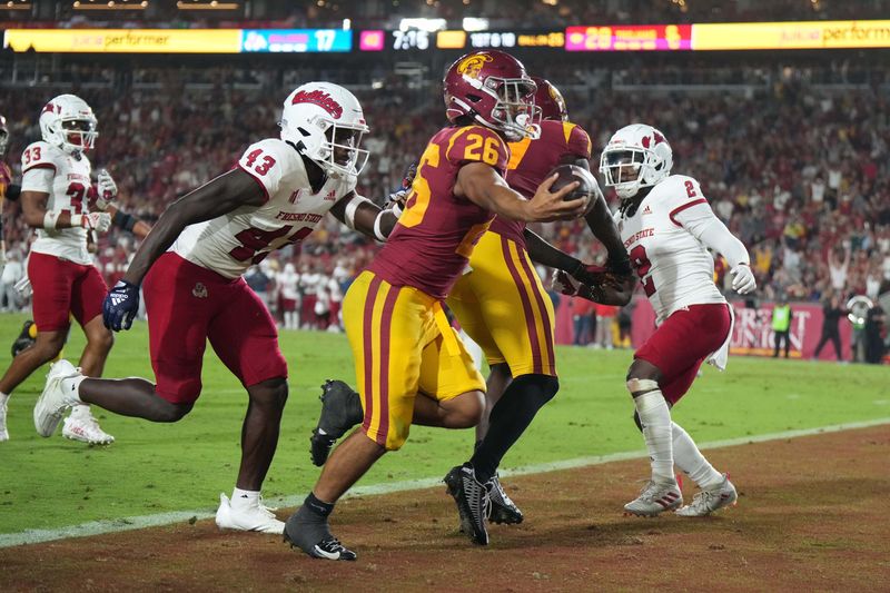 Sep 17, 2022; Los Angeles, California, USA; Southern California Trojans running back Travis Dye (26) scores a touchdown against the Fresno State Bulldogs in the second half at United Airlines Field at Los Angeles Memorial Coliseum. Mandatory Credit: Kirby Lee-USA TODAY Sports