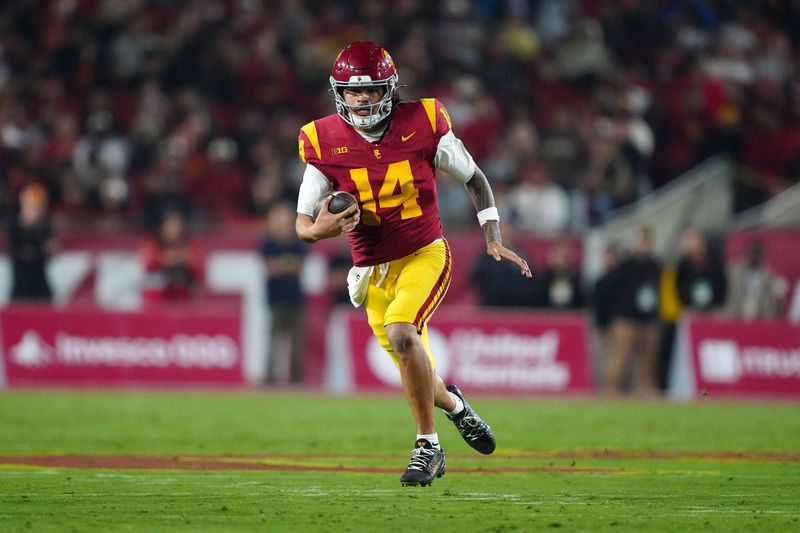 Nov 29, 2025; Los Angeles, California, USA; Southern California Trojans quarterback Jayden Maiava (14) carries the ball against the UCLA Bruins in the first half at United Airlines Field at Los Angeles Memorial Coliseum. Mandatory Credit: Kirby Lee-Imagn Images