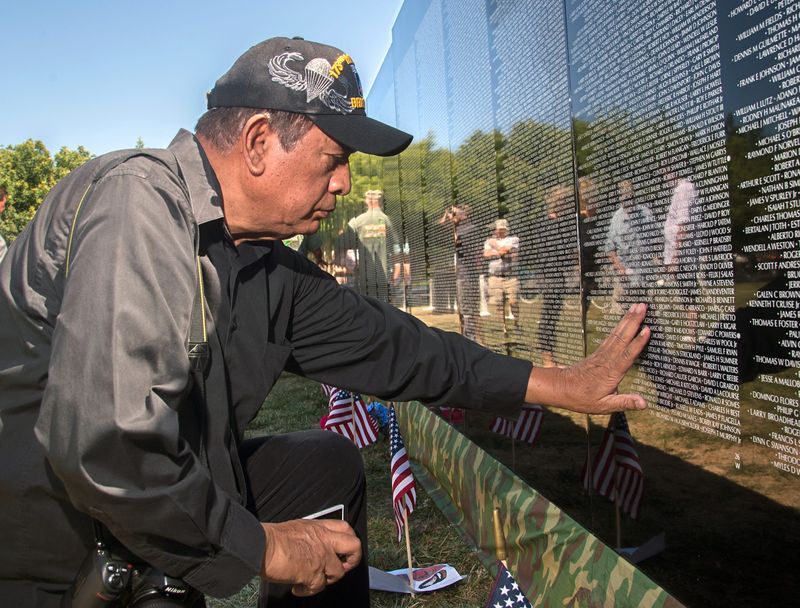 Vietnam veteran Daniel Williams of Stockton teaches out to touch the name of the only comrade that he lost from his platoon on the Moving Wall display at the Weber Point Events Center in downtown Stockton on June 22, 2019.