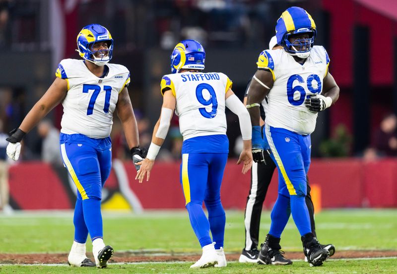 Dec 7, 2025; Glendale, Arizona, USA; Los Angeles Rams quarterback Matthew Stafford (9) celebrates a touchdown with offensive lineman Warren McClendon Jr. (71) and Kevin Dotson (69) against the Arizona Cardinals at State Farm Stadium. Mandatory Credit: Mark J. Rebilas-Imagn Images