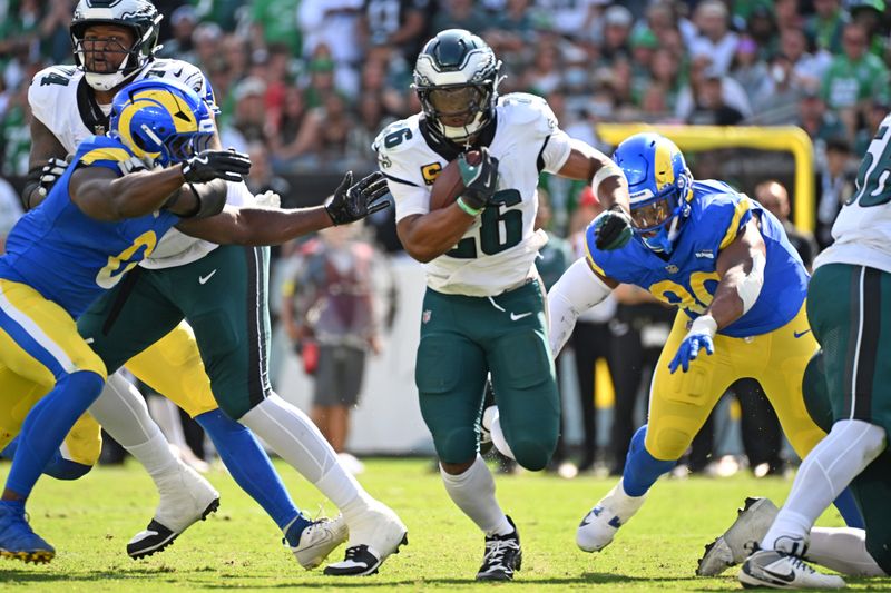 Sep 21, 2025; Philadelphia, Pennsylvania, USA; Philadelphia Eagles running back Saquon Barkley (26) runs with the ball against the Los Angeles Rams at Lincoln Financial Field. Mandatory Credit: Eric Hartline-Imagn Images
