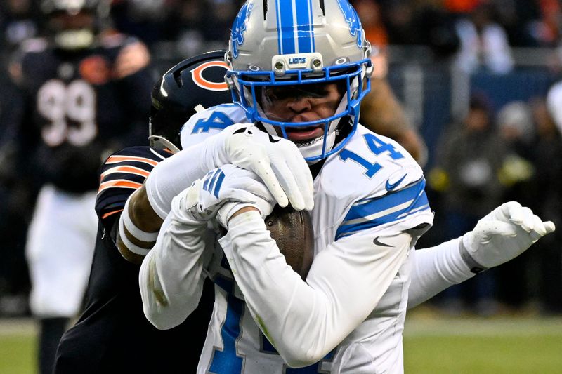 Jan 4, 2026; Chicago, Illinois, USA; Detroit Lions wide receiver Amon-Ra St. Brown (14) runs with the ball against Chicago Bears safety Jaquan Brisker (9) during the first half at Soldier Field. Mandatory Credit: Matt Marton-Imagn Images