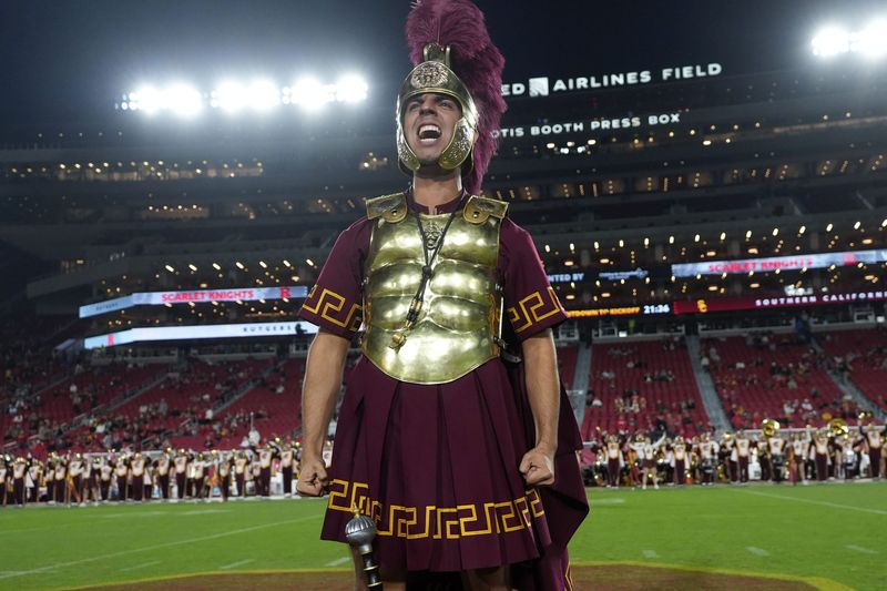 Oct 25, 2024; Los Angeles, California, USA; Southern California Trojans mascot Tommy Trojan leads the Spirit of Troy marching band onto the field during the game against the Rutgers Scarlet Knights at United Airlines Field at Los Angeles Memorial Coliseum. Mandatory Credit: Kirby Lee-Imagn Images