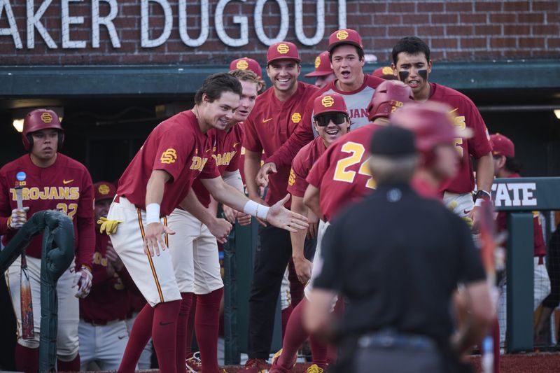 May 31, 2025; Corvallis, OR, USA; USC catcher Augie Lopez (24) celebrates with teammates after hitting a home run in the fifth inning against Saint Mary's at the NCAA Corvallis Regional at Goss Stadium. Mandatory Credit: Troy Wayrynen-Imagn Images