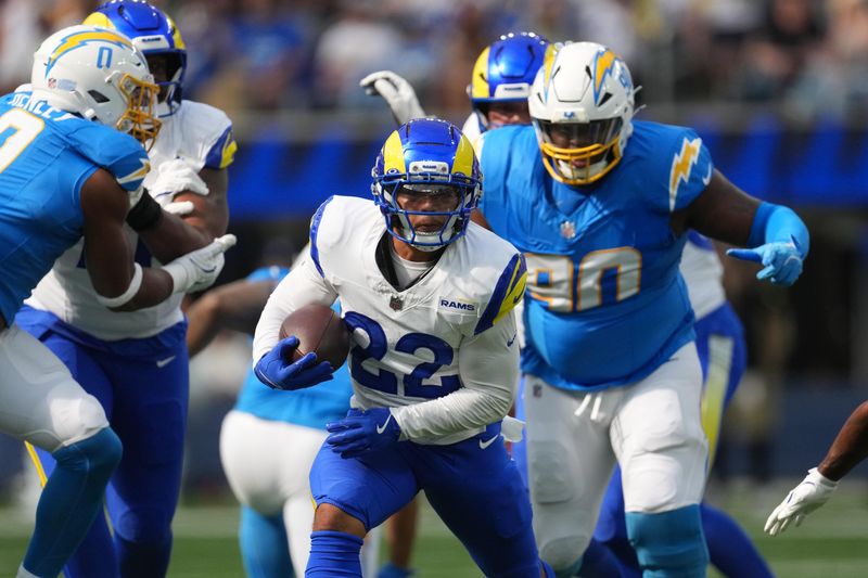 Aug 16, 2025; Inglewood, California, USA; Los Angeles Rams running back Blake Corum (22) carries the ball against the Los Angeles Chargers in the first half at SoFi Stadium. Mandatory Credit: Kirby Lee-Imagn Images