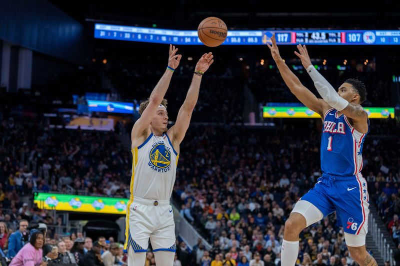 Jan 30, 2024; San Francisco, California, USA; Golden State Warriors guard Brandin Podziemski (2) shoots a three point basket against Philadelphia 76ers forward KJ Martin (1) during the fourth quarter at Chase Center. Mandatory Credit: Neville E. Guard-USA TODAY Sports