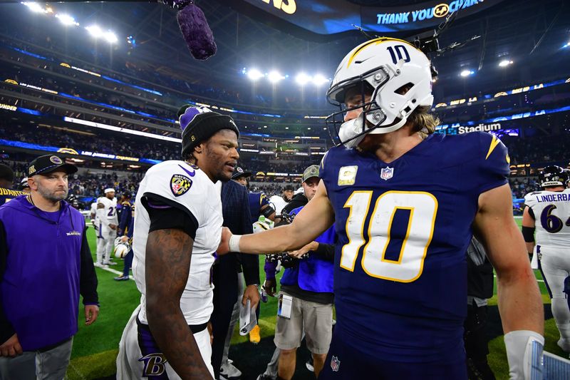Nov 25, 2024; Inglewood, California, USA; Baltimore Ravens quarterback Lamar Jackson (8) meets with Los Angeles Chargers quarterback Justin Herbert (10) following the game at SoFi Stadium. Mandatory Credit: Gary A. Vasquez-Imagn Images