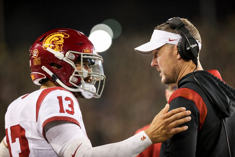 USC Trojans quarterback Caleb Williams (13) talks with USC Trojans head coach Lincoln Riley during the first half of the game against No. 6 Oregon Ducks on Saturday, Nov. 11, 2023, at Autzen Stadium in Eugene, Ore.