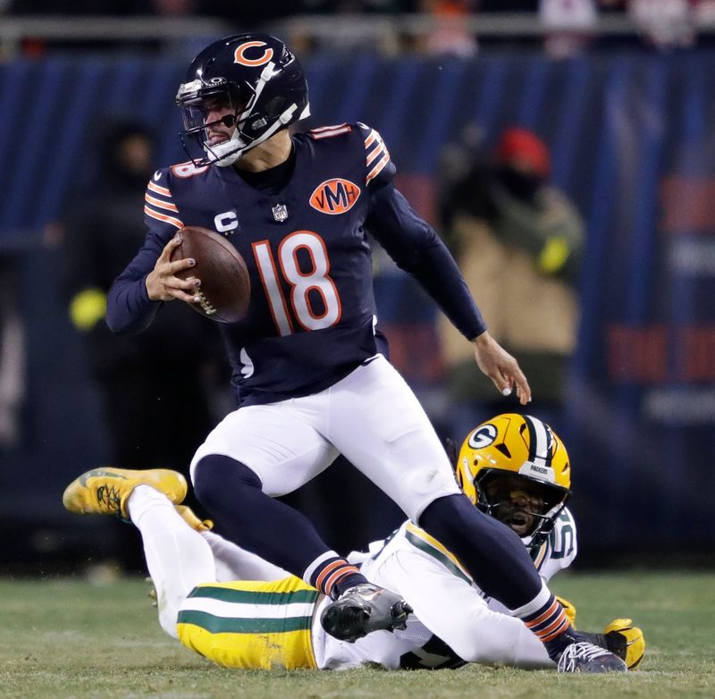 Chicago Bears quarterback Caleb Williams (18) eludes Green Bay Packers defensive end Rashan Gary (52) during their football game Saturday, December 20, 2025, at Soldier Field in Chicago, Illinois.