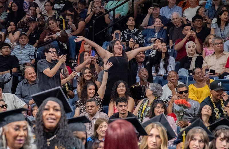 Family and friends watch as graduates march in during the processional at the San Joaquin Delta College graduation at the Adventist Health Arena in downtown Stockton on May, 14, 2026.