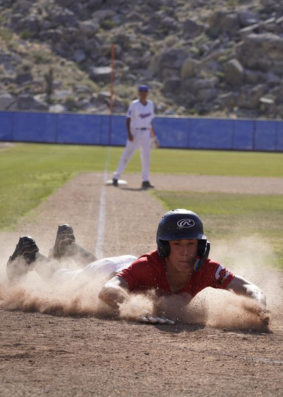 A Santa Clarita Christian player dives into home during the sixth inning against Academy for Academic Excellence in the first round of the CIF-Southern Section Division 8 playoffs on Thursday, May 14, 2026.