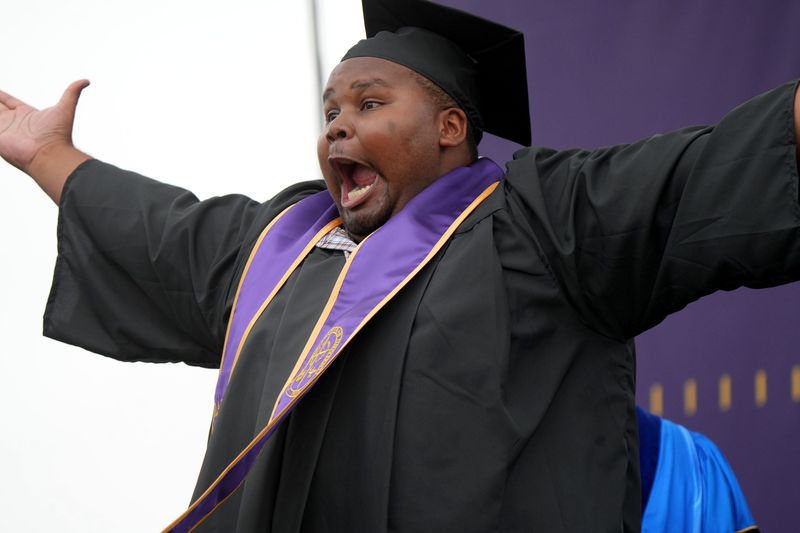 Michael Richardson gets excited after receiving his diploma at the 63rd annual California Lutheran University commencement in Thousand Oaks May 15. More than 1,000 students accepted diplomas during two ceremonies.