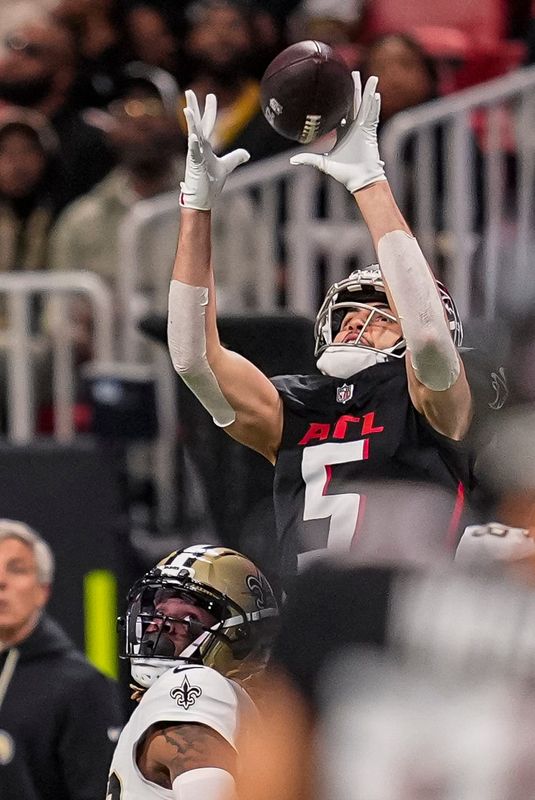Jan 4, 2026; Atlanta, Georgia, USA; Atlanta Falcons wide receiver Drake London (5) catches a pass over New Orleans Saints cornerback Quincy Riley (29) during the second half at Mercedes-Benz Stadium. Mandatory Credit: Dale Zanine-Imagn Images