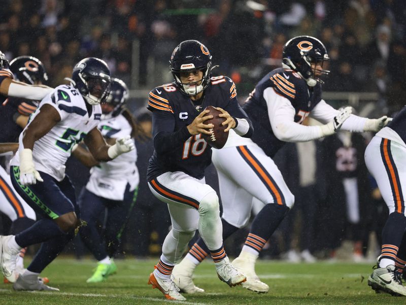Dec 26, 2024; Chicago, Illinois, USA; Chicago Bears quarterback Caleb Williams (18) rolls out of the pocket during the third quarter against the Seattle Seahawks at Soldier Field. Mandatory Credit: Talia Sprague-Imagn Images