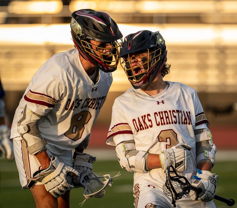 Oaks Christian's Chase Macleod (left) and Asher Wolfe celebrate during the CIF-SS Division 3 boys lacrosse championship on Friday, May 15, 2026, at Fred Kelly Stadium in Orange. Oaks Christian defeated Dana Hills, 16-11.