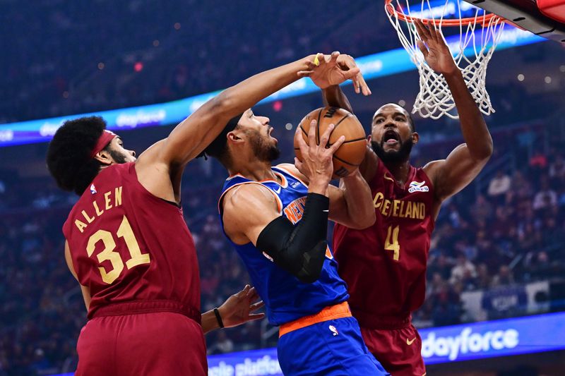 Apr 2, 2025; Cleveland, Ohio, USA; New York Knicks guard Josh Hart (3) drives to the basket between Cleveland Cavaliers center Jarrett Allen (31) and forward Evan Mobley (4) during the first quarter at Rocket Arena. Mandatory Credit: Ken Blaze-Imagn Images