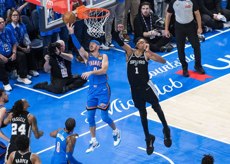 May 18, 2026; Oklahoma City, Oklahoma, USA; Oklahoma City Thunder guard Alex Caruso (9) shoots while defended by San Antonio Spurs center Victor Wembanyama (1) in double overtime during game one of the western conference finals for the 2026 NBA playoffs at Paycom Center. Mandatory Credit: Brett Rojo-Imagn Images