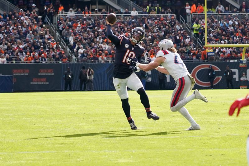 Nov 10, 2024; Chicago, Illinois, USA; Chicago Bears quarterback Caleb Williams (18) passes against the New England Patriots during the first half at Soldier Field. Mandatory Credit: David Banks-Imagn Images