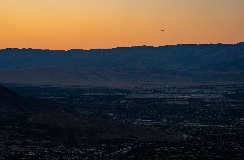A plane heads in to land at Palm Springs International Airport as the sun sets on the Coachella Valley in Palm Desert, Calif., Tuesday, May 19, 2026.
