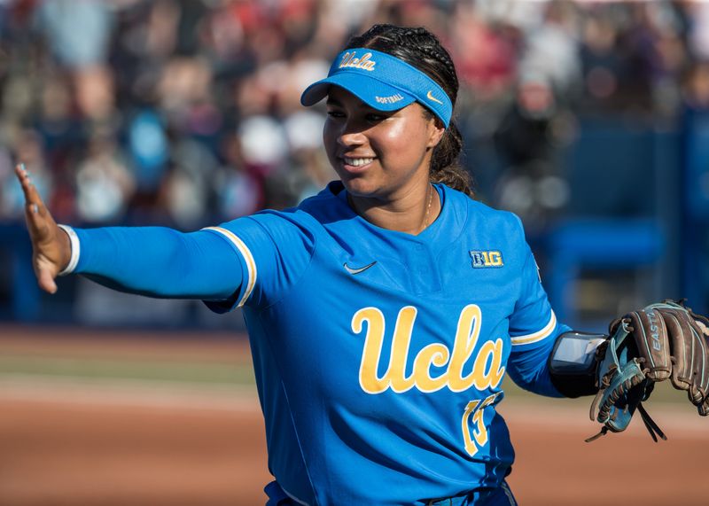 May 31, 2025; Oklahoma City, OK, USA; UCLA Bruins infielder Jordan Woolery (15) reaches out to slap hands with a teammate in the first inning against the Texas Tech Red Raiders during the NCAA Softball Women's College World Series at Devon Park. Mandatory Credit: Brett Rojo-Imagn Images