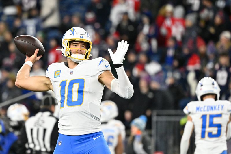 Jan 11, 2026; Foxborough, MA, USA; Los Angeles Chargers quarterback Justin Herbert (10) warms up before the game against the New England Patriots in an AFC Wild Card Round game at Gillette Stadium. Mandatory Credit: Eric Canha-Imagn Images