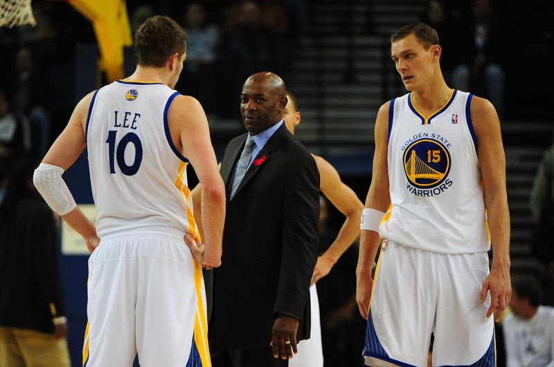 November 30, 2010; Oakland, CA, USA; Golden State Warriors head coach Keith Smart (center) talks to center David Lee (10) during the third quarter against the San Antonio Spurs at ORACLE Arena. The Spurs defeated the Warriors 118-98. Mandatory Credit: Kyle Terada-USA TODAY Sports