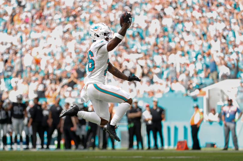Nov 19, 2023; Miami Gardens, Florida, USA; Miami Dolphins running back Salvon Ahmed (26) reacts after scoring a touchdown against the Las Vegas Raiders during the second quarter at Hard Rock Stadium. Mandatory Credit: Sam Navarro-USA TODAY Sports