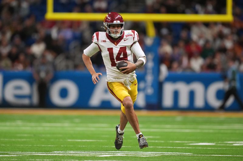Dec 30, 2025; San Antonio, TX, USA; Southern California Trojans quarterback Jayden Maiava (14) carries the ball against the TCU Horned Frogs in the second half during the Alamo Bowl at Alamodome. Mandatory Credit: Kirby Lee-Imagn Images