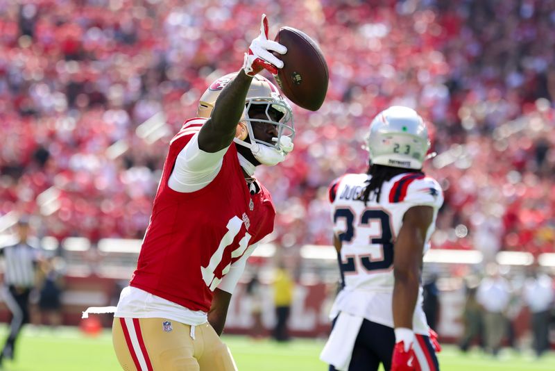 Sep 29, 2024; Santa Clara, California, USA; San Francisco 49ers wide receiver Brandon Aiyuk (11) celebrates after a catch against the New England Patriots during the first quarter at Levi's Stadium. Mandatory Credit: Sergio Estrada-Imagn Images